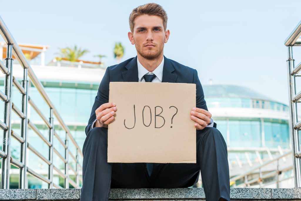 Person holding a Jobs? sign, a key question that needs to be answered in preparing for AGI.